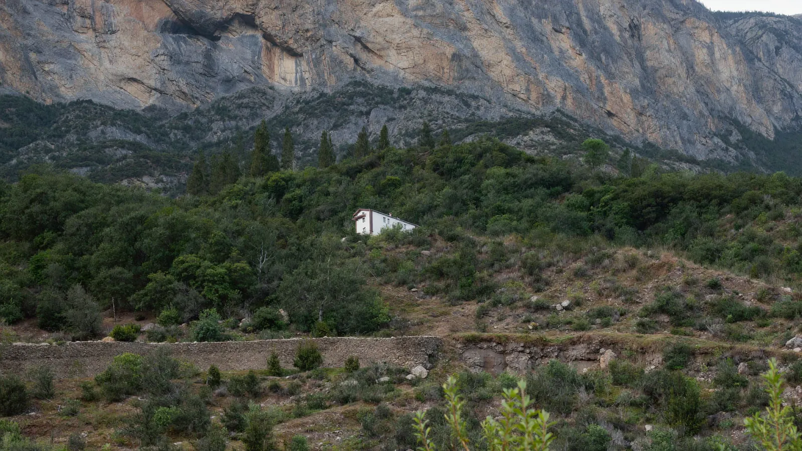 Maison sur un versant boisé au pied d'un relief rocheux près de Chambéry